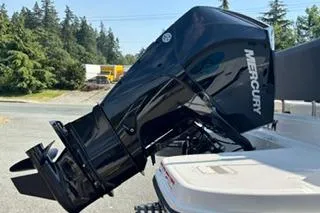 Slide: The Image of 2023 Bayliner 1703 Trophy boat with a Mercury outboard motor, parked outdoors. - 3