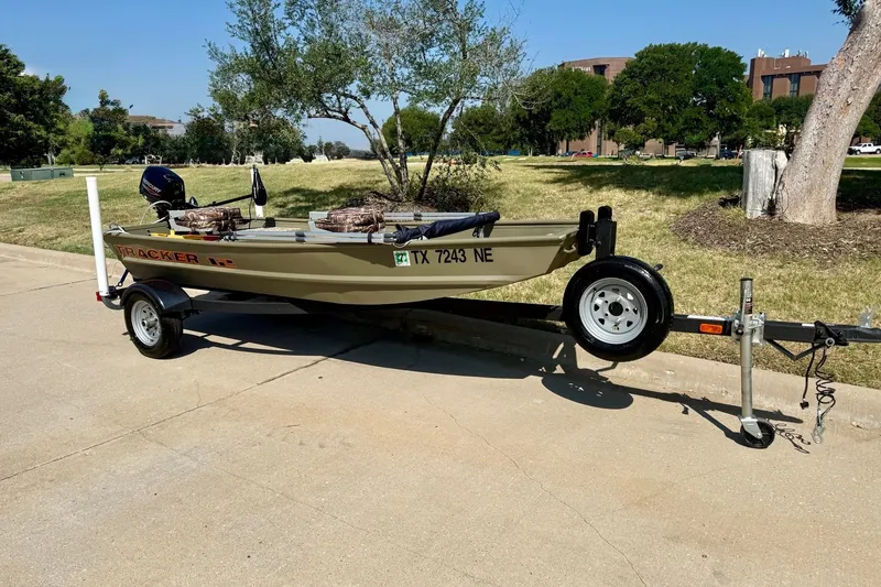 The Image of 2026 Tracker Grizzly 12 Jon boat on trailer, parked outdoors on a sunny day. - 0