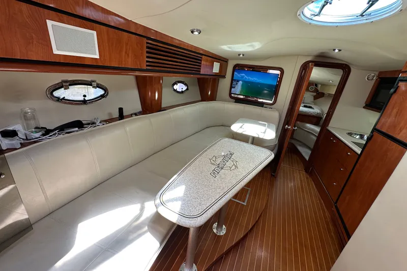 Slide: The Image of Luxurious interior of 2005 Fountain 48 Express Cruiser with elegant wood finishes and plush seating. - 23