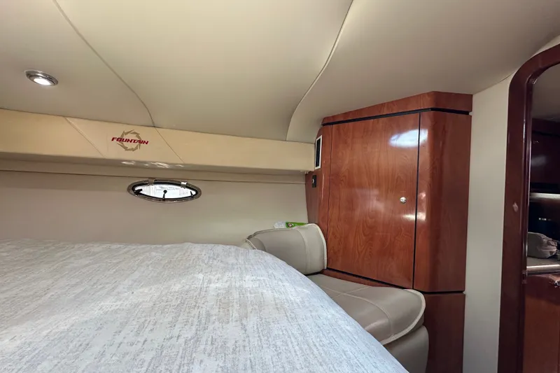 Slide: The Image of Interior cabin of 2005 Fountain 48 Express Cruiser with wood cabinetry and porthole window. - 31