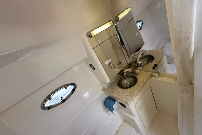 Slide: The Image of Bathroom interior of 2005 Fountain 48 Express Cruiser with dual sinks and porthole window. - 35