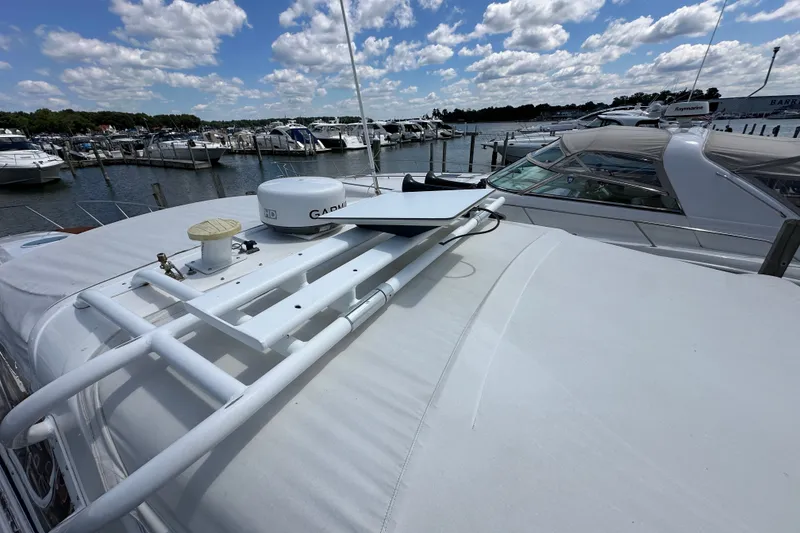 Slide: The Image of 2005 Fountain 48 Express Cruiser docked at marina under blue sky. - 36