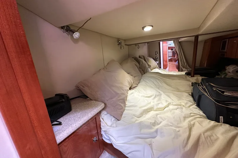 Slide: The Image of Cozy cabin interior of 2005 Fountain 48 Express Cruiser with bed and storage. - 33