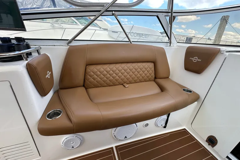 Slide: The Image of Luxurious seating on a 2005 Fountain 48 Express Cruiser with tan leather upholstery. - 16