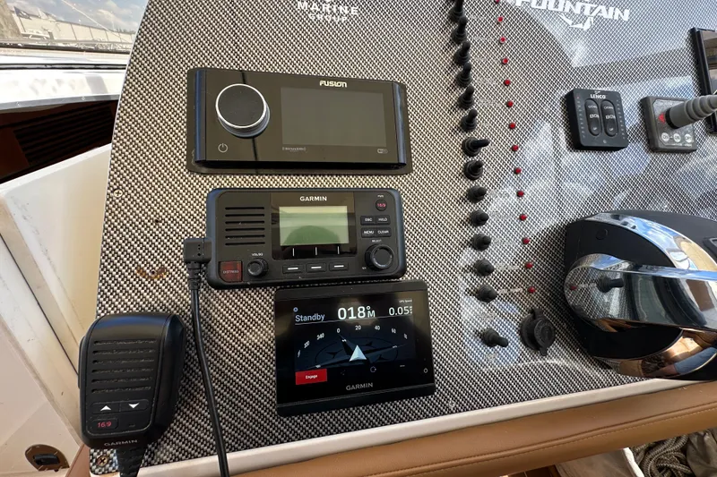 Slide: The Image of Dashboard of a 2005 Fountain 48 Express Cruiser with Garmin and Fusion electronics. - 22