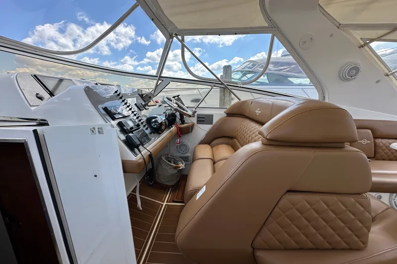 Slide: The Image of Interior of 2005 Fountain 48 Express Cruiser with tan leather seating and control panel. - 17