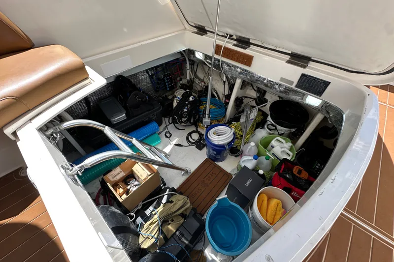 Slide: The Image of Storage compartment of a 2005 Fountain 48 Express Cruiser, filled with boating equipment and supplies. - 39