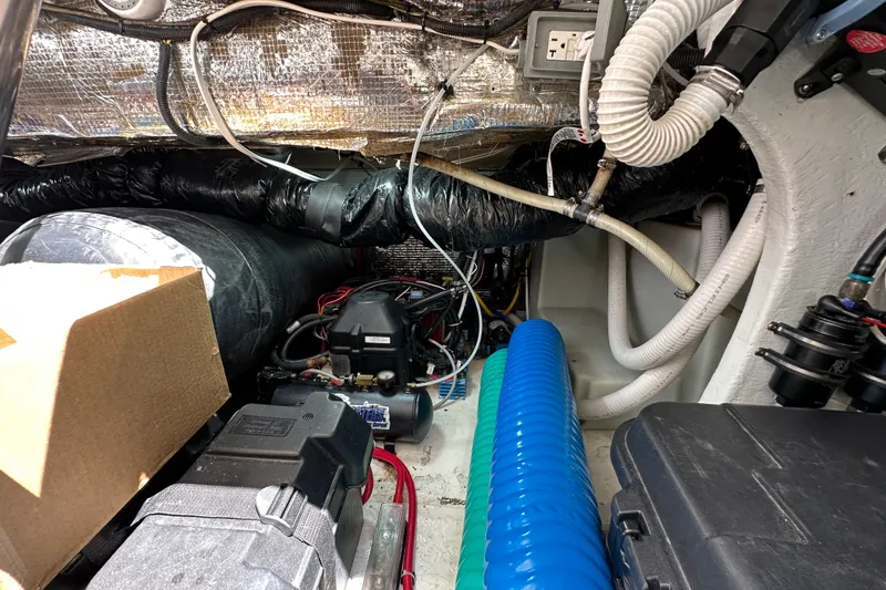 Slide: The Image of Engine room of 2005 Fountain 48 Express Cruiser with various hoses and equipment. - 40