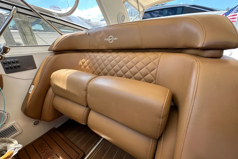Slide: The Image of Luxurious tan leather seating in 2005 Fountain 48 Express Cruiser boat interior. - 18