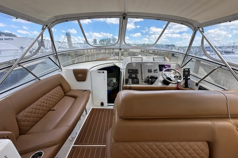 Slide: The Image of 2005 Fountain 48 Express Cruiser cockpit with brown leather seating and modern controls. - 15
