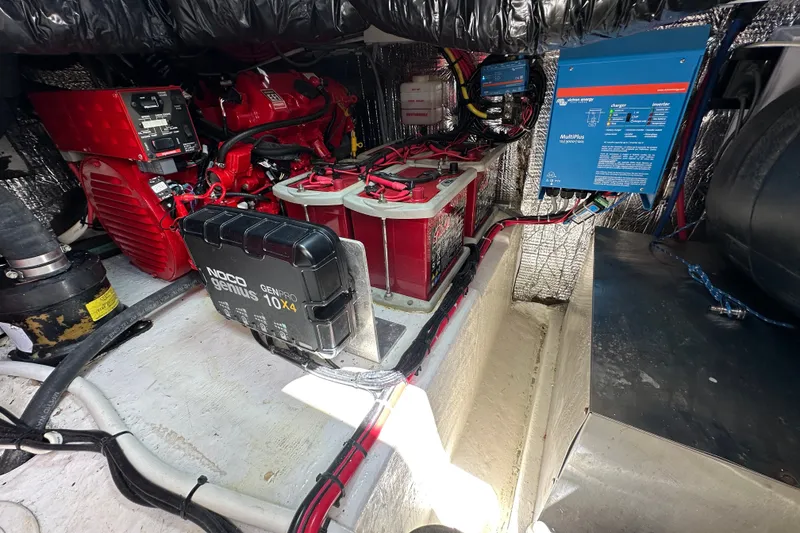 Slide: The Image of Engine room of a 2005 Fountain 48 Express Cruiser with batteries and electrical components. - 42