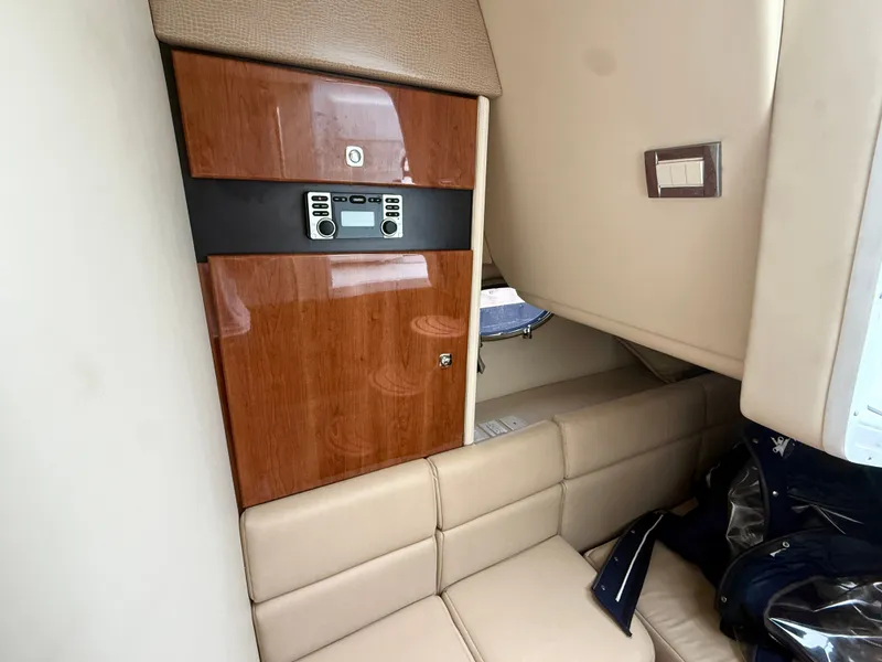 Slide: The Image of Interior of a 2014 Formula 350 Crossover Bowrider with beige upholstery and wood accents. - 27