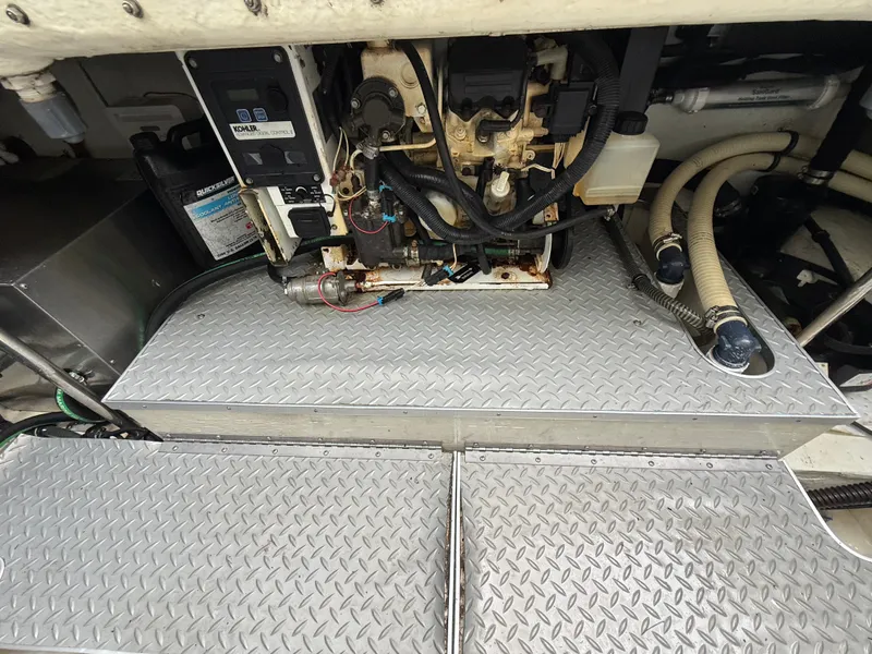 Slide: The Image of The engine room of a boat shows engines and hoses on a metal platform. - 44
