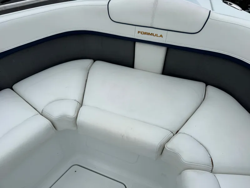 Slide: The Image of The image shows white upholstery in the bow area of a boat with the "Formula" logo. - 34