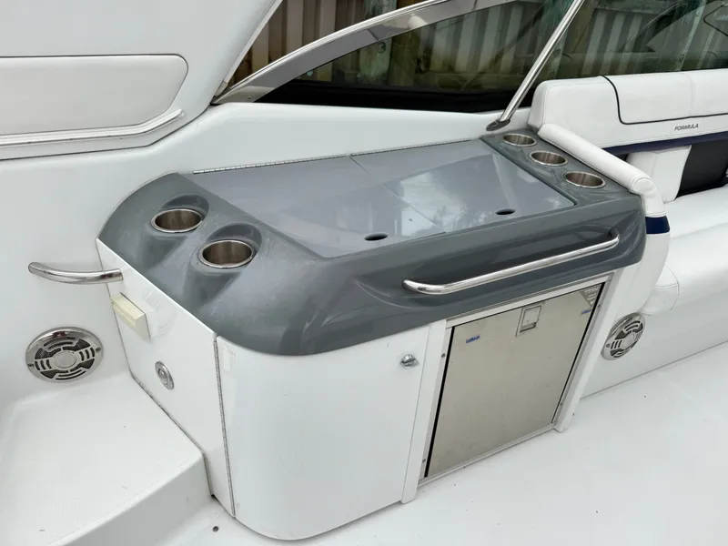 Slide: The Image of The 2014 Formula 350 Crossover Bowrider features a sleek wet bar with cup holders and storage. - 8