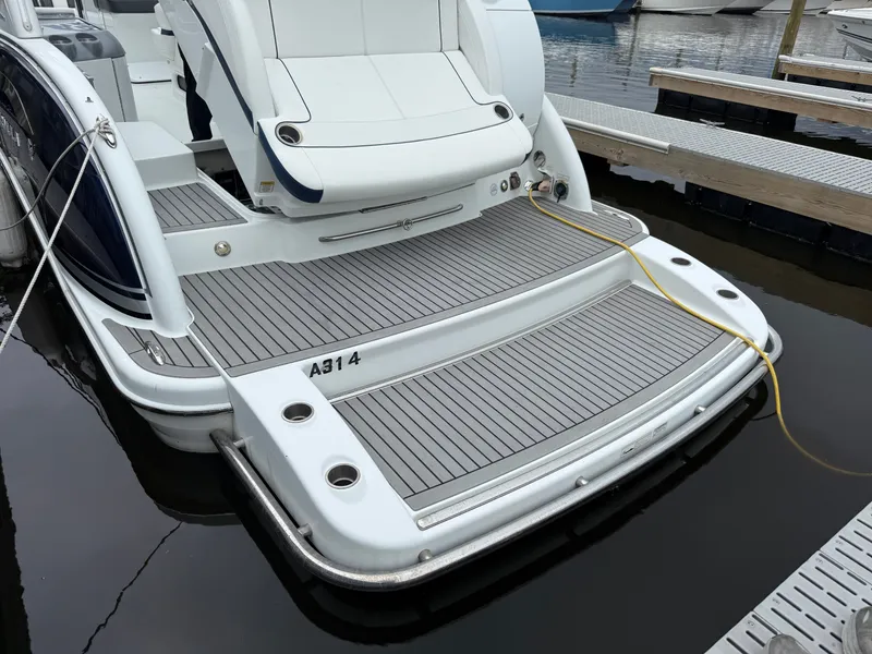 Slide: The Image of The image shows the stern of a 2014 Formula 350 Crossover Bowrider with a large swim platform. - 2