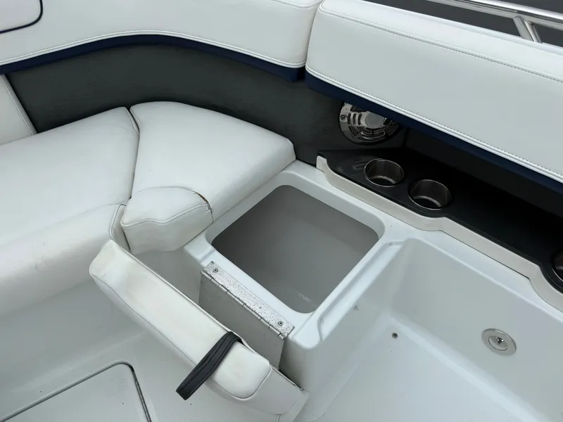 Slide: The Image of The image shows a boat seating area with white upholstery and built-in cup holders. - 37