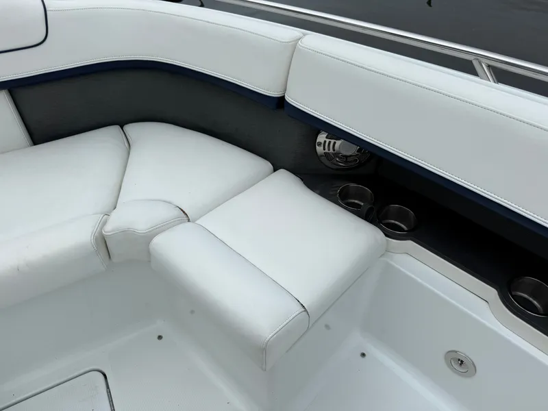 Slide: The Image of The image shows white upholstery and cup holders in the seating area of a boat. - 36