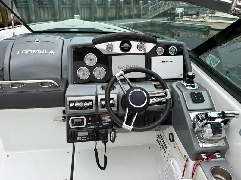 Slide: The Image of The image shows the helm of a 2014 Formula 350 Crossover Bowrider with modern instruments. - 15