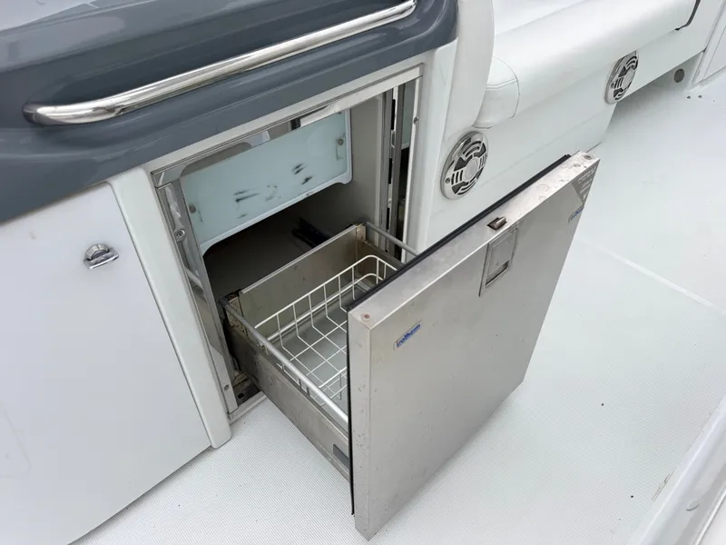 Slide: The Image of An open refrigerator with a pull-out wire basket on a boat. - 10