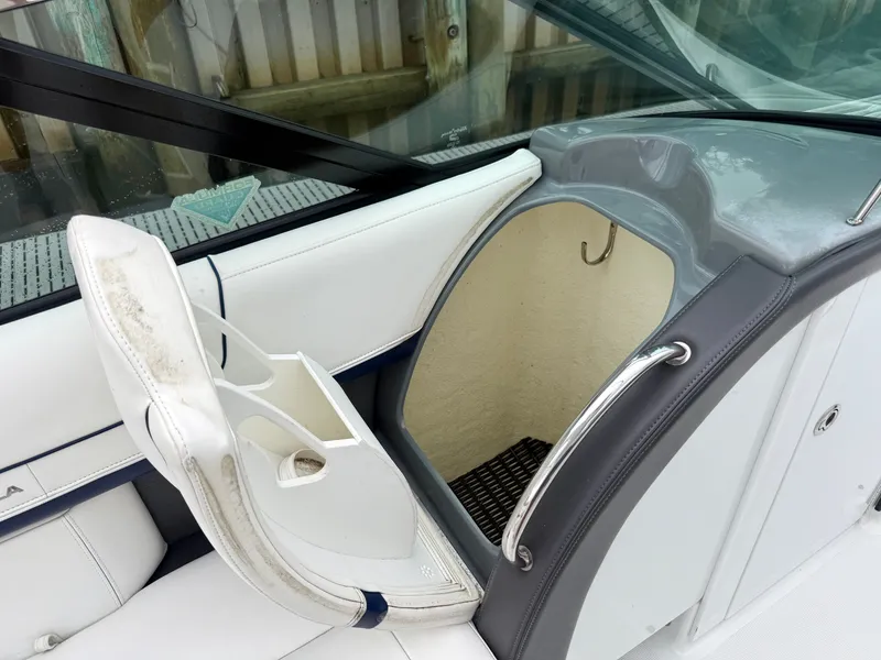 Slide: The Image of The image shows the entrance to a cabin on a boat with white and gray upholstery. - 14