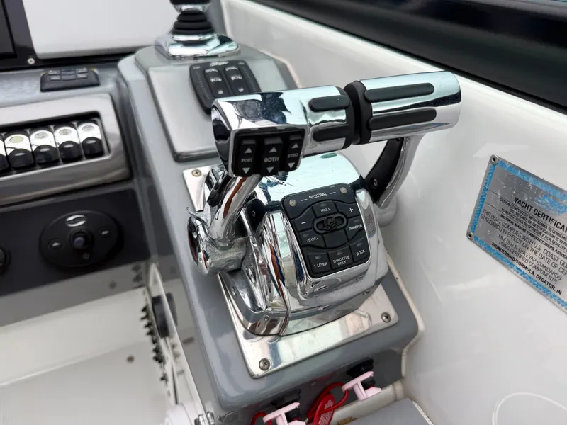 Slide: The Image of Close-up of a boat's control console with shiny levers and switches. - 16