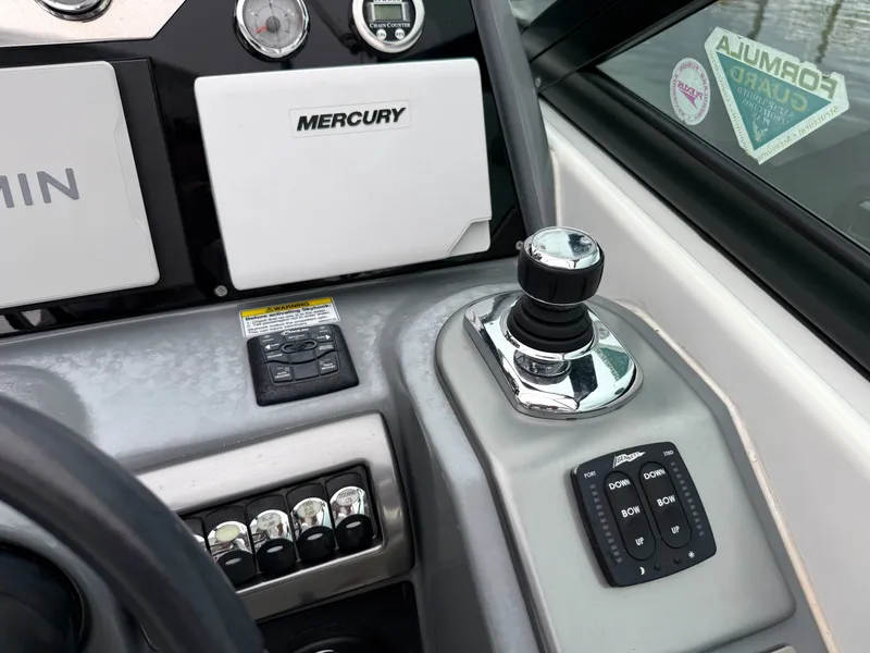 Slide: The Image of The image shows a boat's helm with a joystick, switches, and instruments. - 17