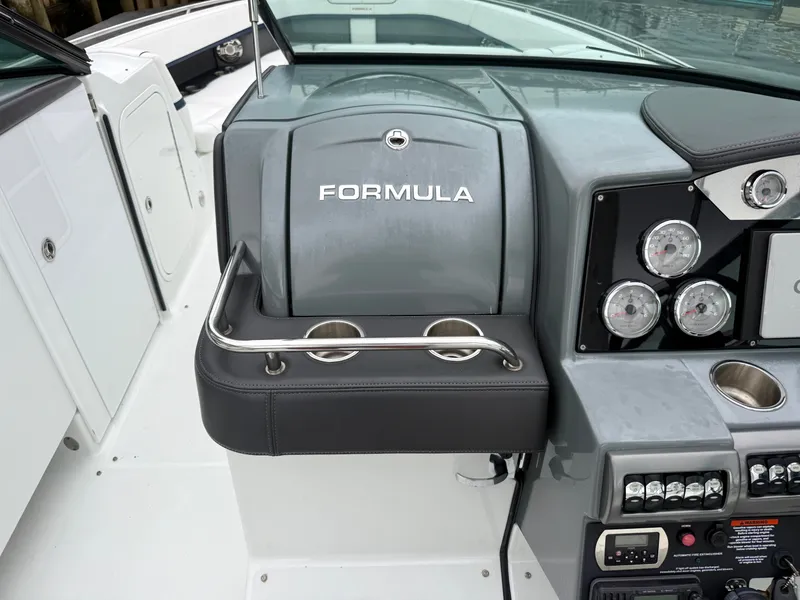 Slide: The Image of The image shows the cockpit of a 2014 Formula 350 Crossover Bowrider with a gray dashboard and instruments. - 21