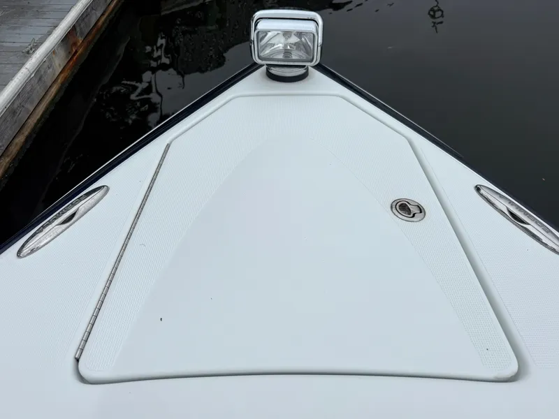 Slide: The Image of The bow of a white boat with a spotlight and a metal latch. - 38