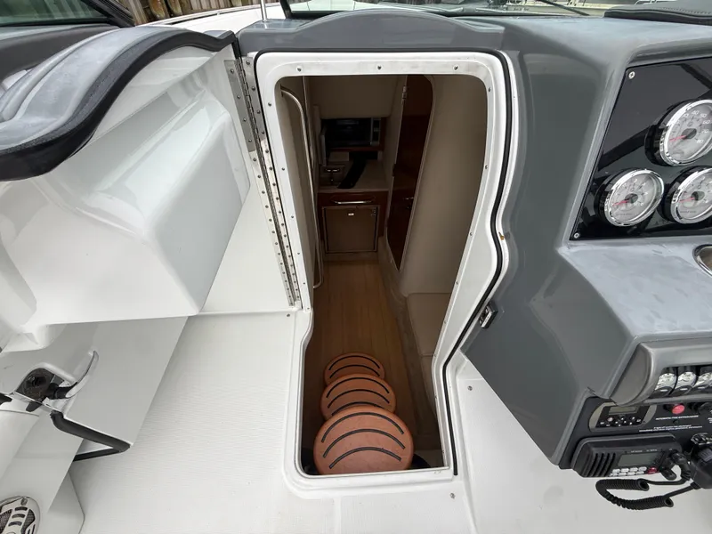 Slide: The Image of The image shows the cabin entrance of a 2014 Formula 350 Crossover Bowrider with dashboard. - 23