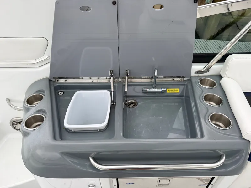 Slide: The Image of The boat's kitchenette features a sink, faucet, and cup holders. - 9