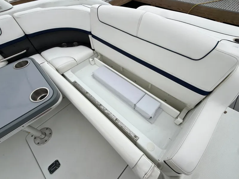 Slide: The Image of The image shows a white bench seat with storage underneath on a boat. - 5