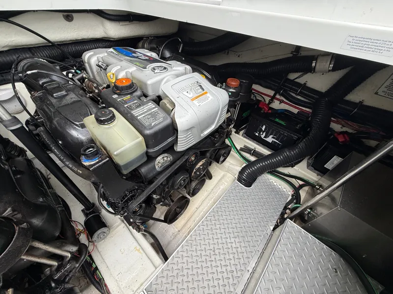 Slide: The Image of A clean engine compartment with a well-maintained engine and batteries, surrounded by cables and hoses. - 43