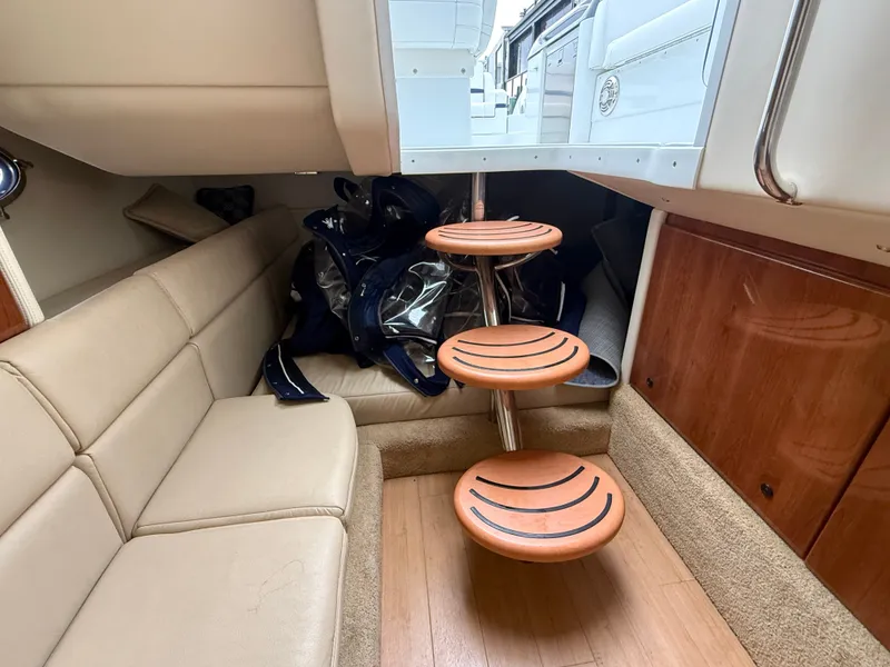 Slide: The Image of Interior of a 2014 Formula 350 Crossover Bowrider with beige sofa and wooden steps. - 28