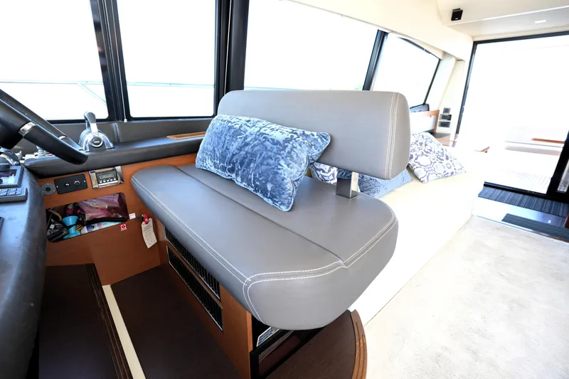 Slide: The Image of Interior of 2013 Prestige 500 yacht with gray seating and blue cushions. - 60