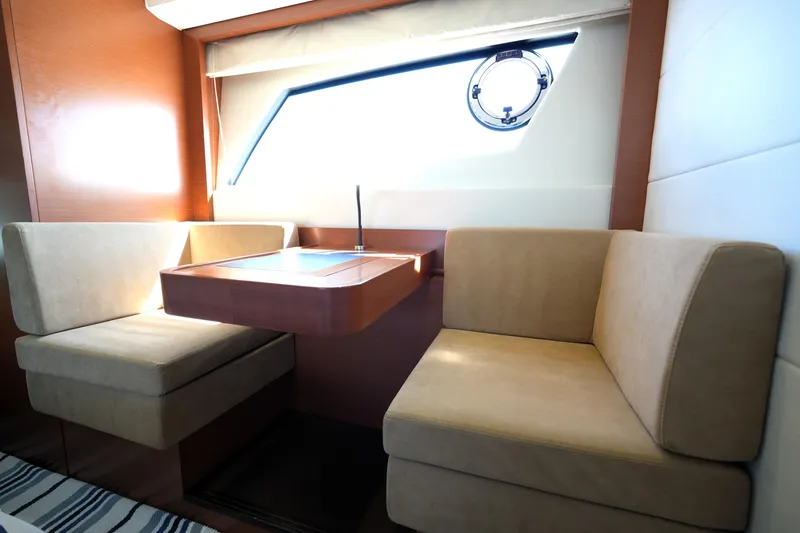 Slide: The Image of Luxurious interior of a 2013 Prestige 500 yacht with cozy seating and a window view. - 82