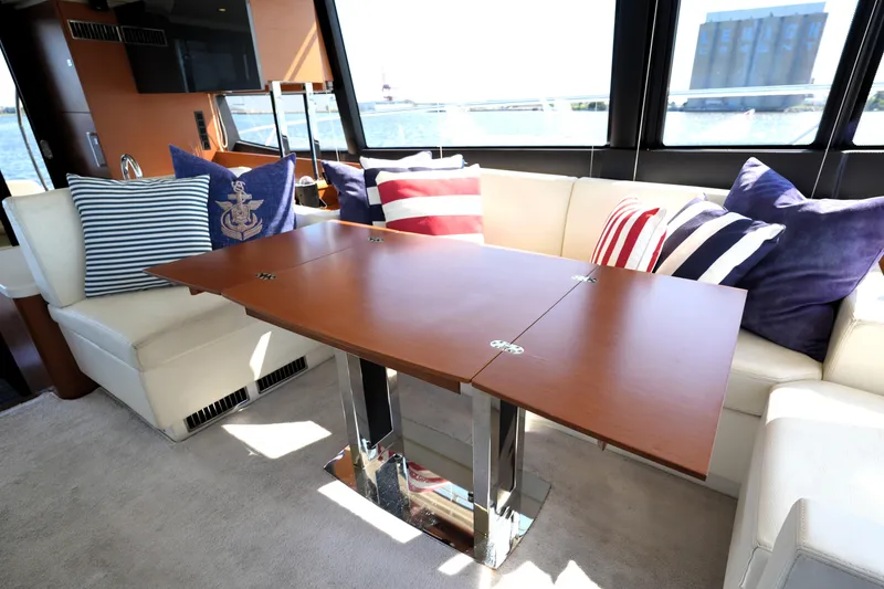 Slide: The Image of Luxurious interior of 2013 Prestige 500 yacht with nautical-themed cushions and elegant wooden table. - 55