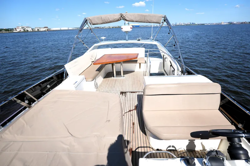 Slide: The Image of Luxurious 2013 Prestige 500 yacht with spacious deck and seating, cruising on open water. - 27