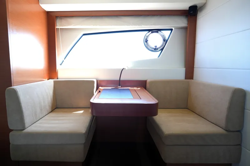 Slide: The Image of Interior of 2013 Prestige 500 yacht with cozy seating and window view. - 81