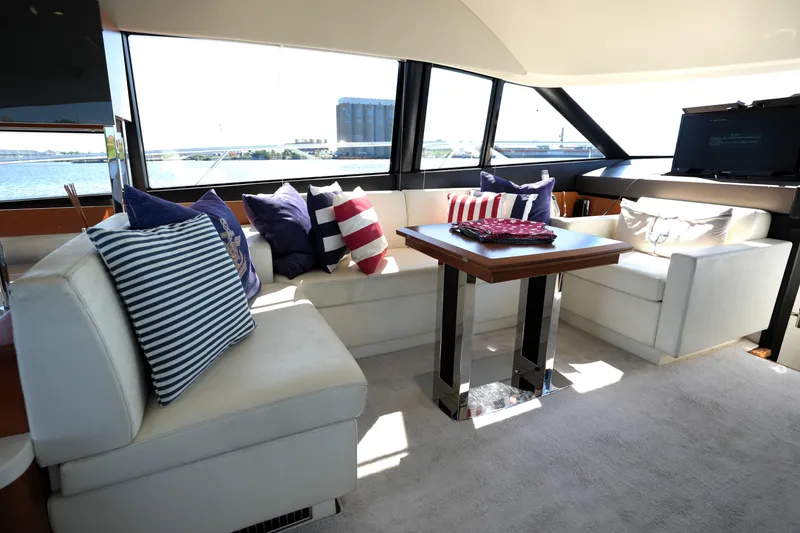 Slide: The Image of Luxurious interior of 2013 Prestige 500 yacht with stylish seating and nautical-themed cushions. - 54