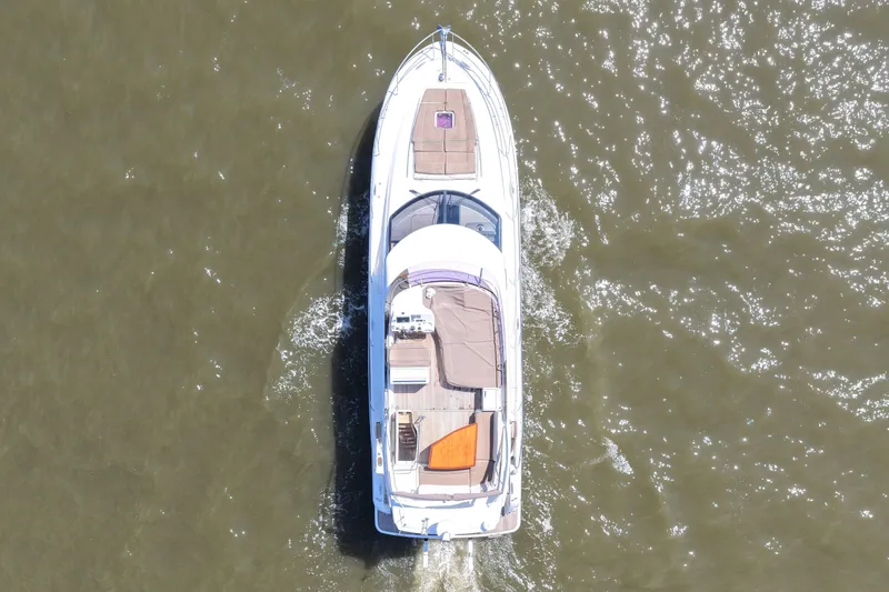 Slide: The Image of Aerial view of a 2013 Prestige 500 yacht cruising on water. - 13