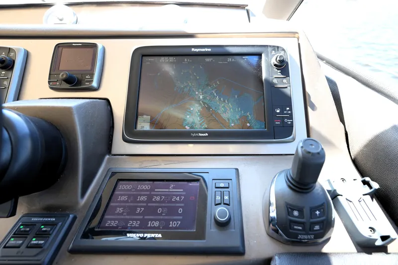 Slide: The Image of Control panel of a 2013 Prestige 500 yacht with navigation and engine displays. - 64