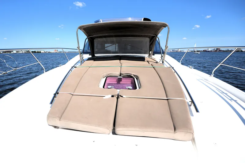 Slide: The Image of 2013 Prestige 500 yacht with sunbathing deck on calm water under clear blue sky. - 37