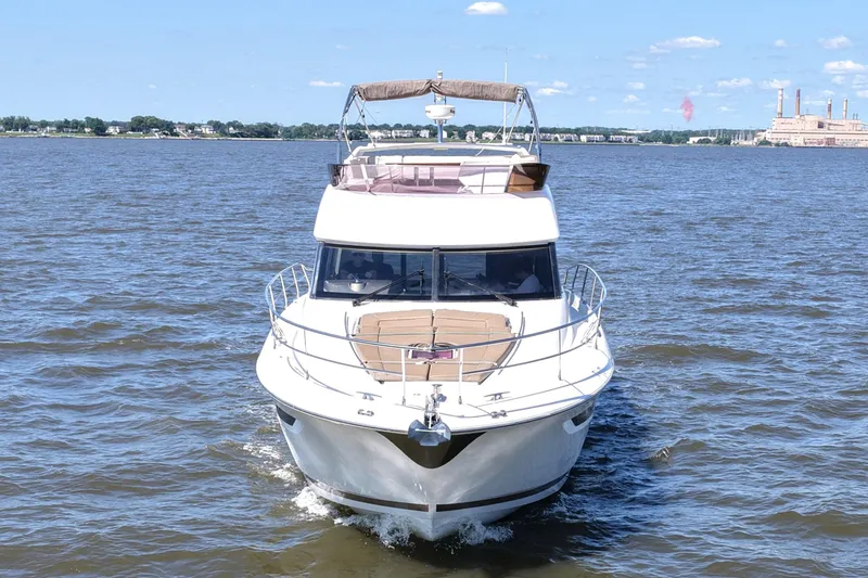 Slide: The Image of 2013 Prestige 500 yacht cruising on open water under clear blue sky. - 7