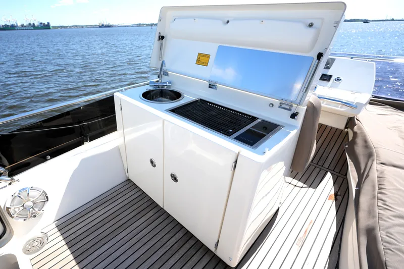 Slide: The Image of Outdoor kitchen on 2013 Prestige 500 yacht with grill and sink, overlooking the water. - 31