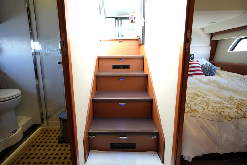 Slide: The Image of Interior of 2013 Prestige 500 yacht showing stairs, bathroom, and bedroom. - 73