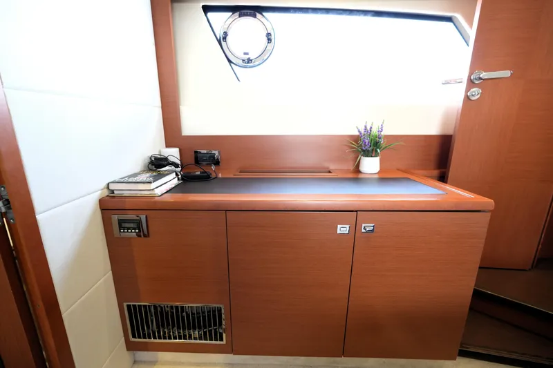 Slide: The Image of Interior of 2013 Prestige 500 yacht with wooden cabinetry and porthole window. - 80