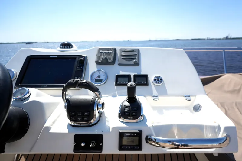 Slide: The Image of Control panel of a 2013 Prestige 500 yacht with navigation equipment and steering wheel. - 34