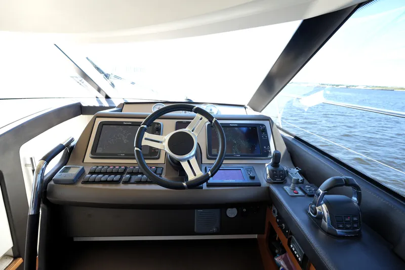 Slide: The Image of Cockpit of 2013 Prestige 500 yacht with navigation screens and steering wheel. - 61