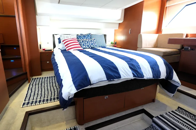 Slide: The Image of Luxurious cabin interior of 2013 Prestige 500 yacht with striped bedding and modern decor. - 78